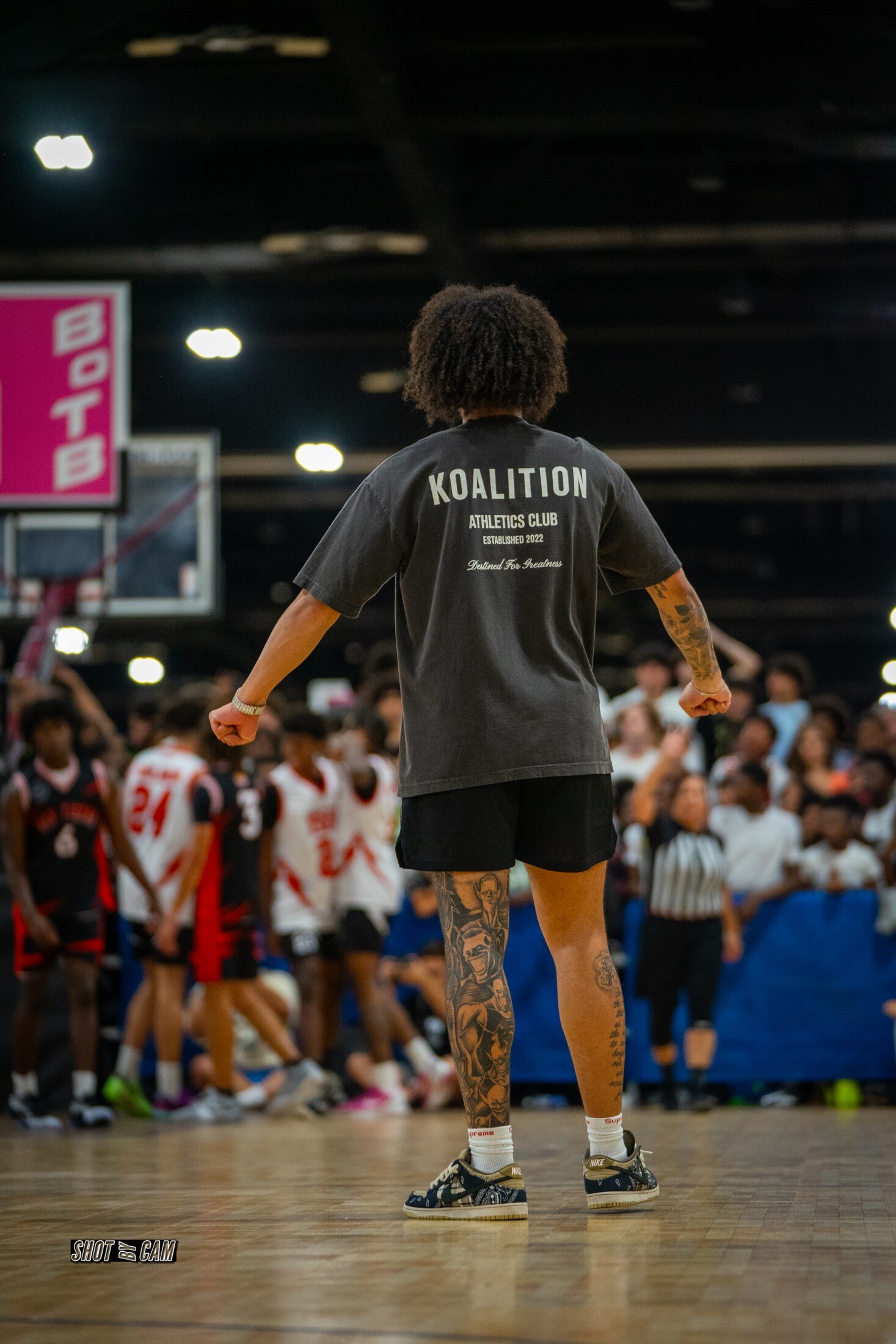 Athlete introduced in front of a packed gym