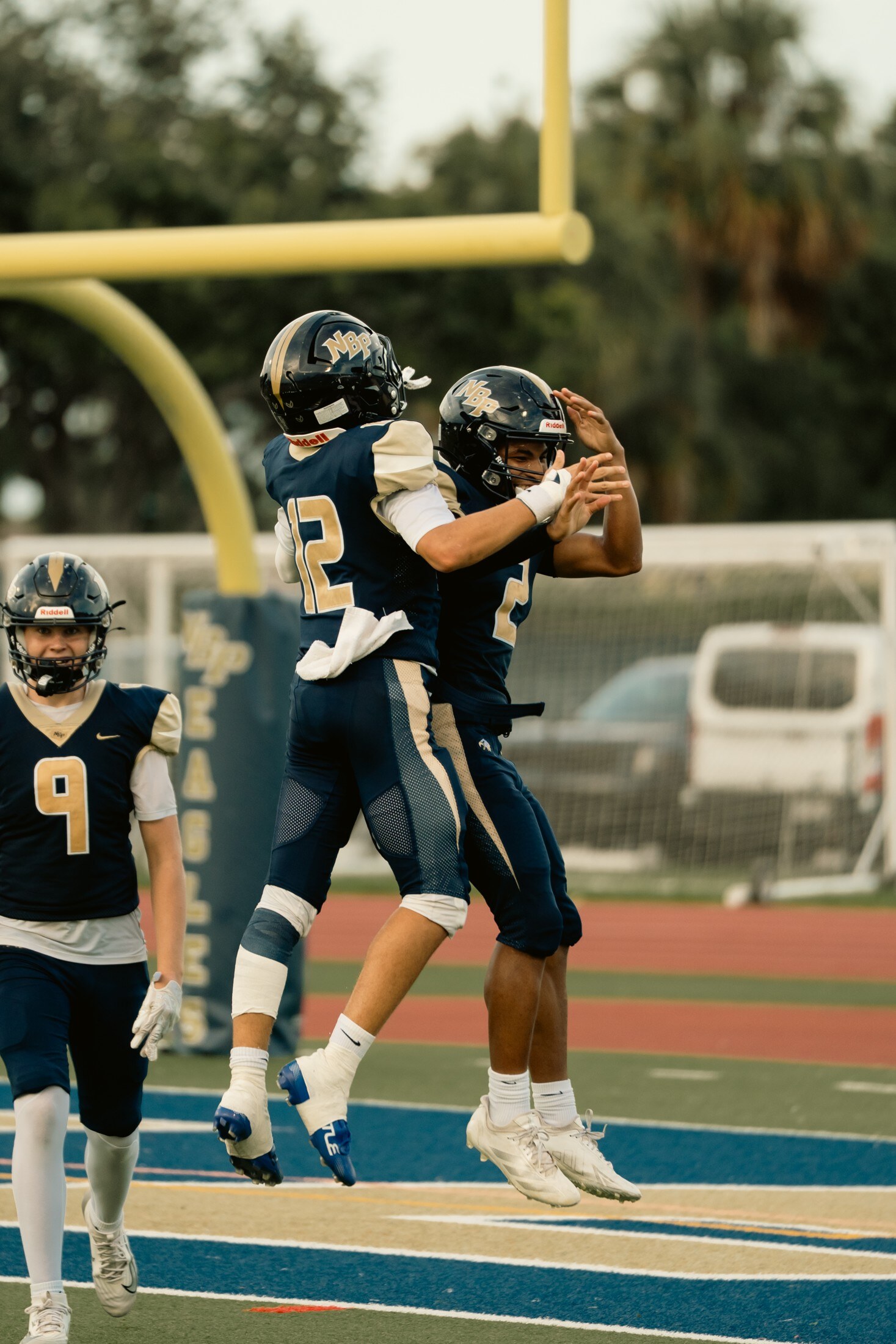 Football players celebrating a touchdown in the end zone