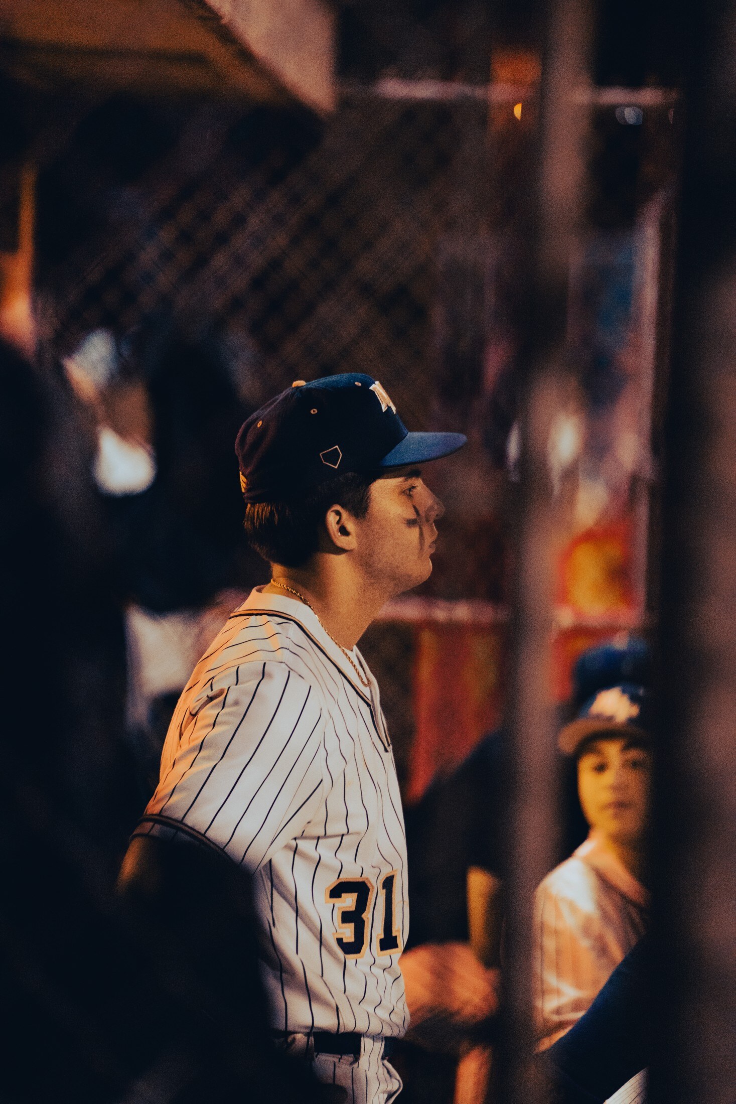 Baseball player watching from the dugout