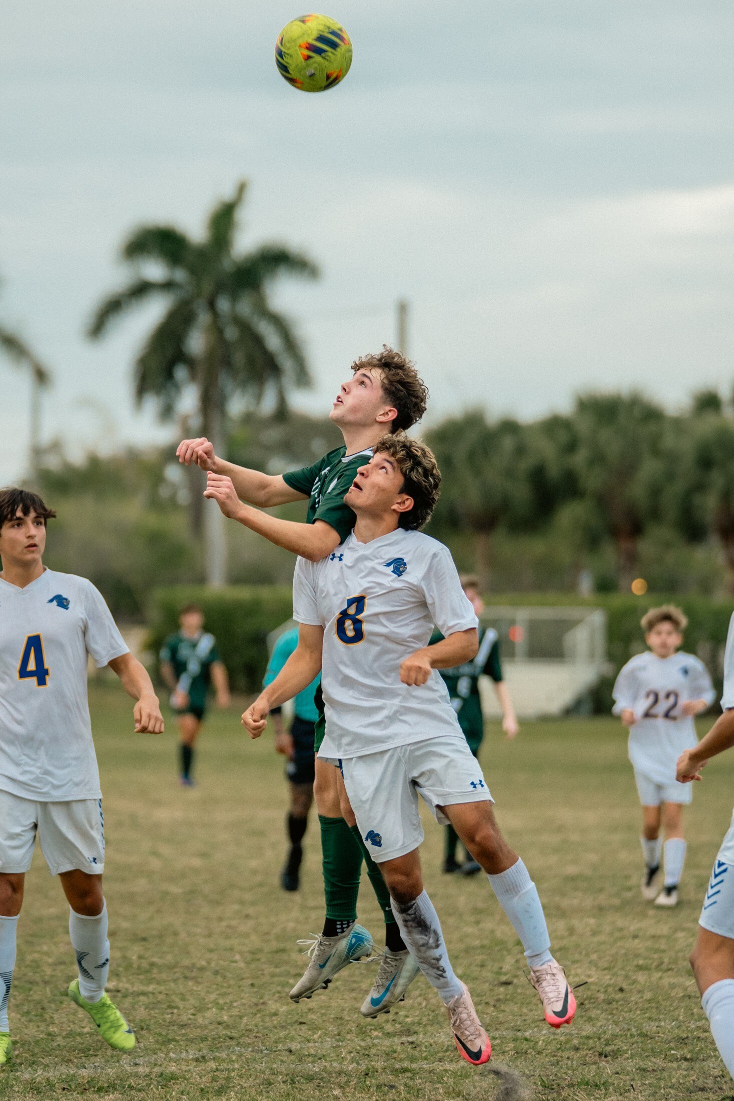 Soccer players rising for a header