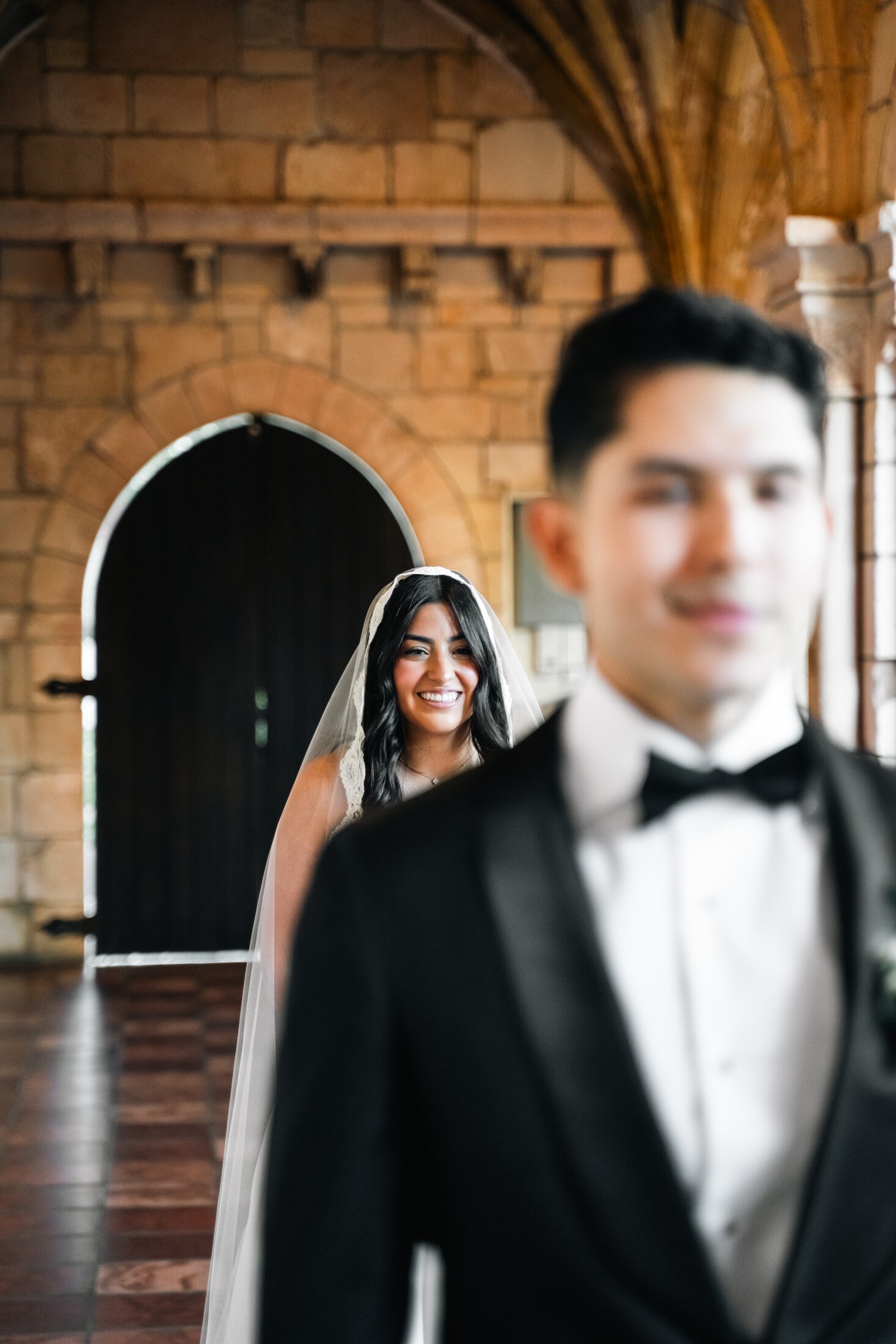 Bride and groom outside a stone chapel